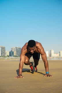 Athlete doing HIIT on the beach